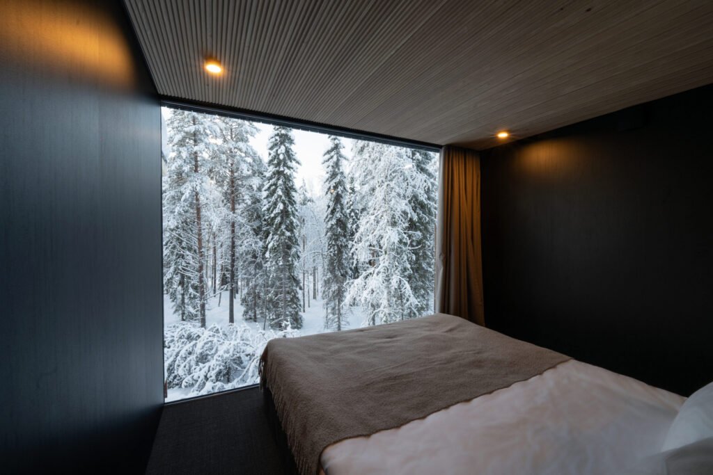 Deluxe villa bedroom with snowy forest view