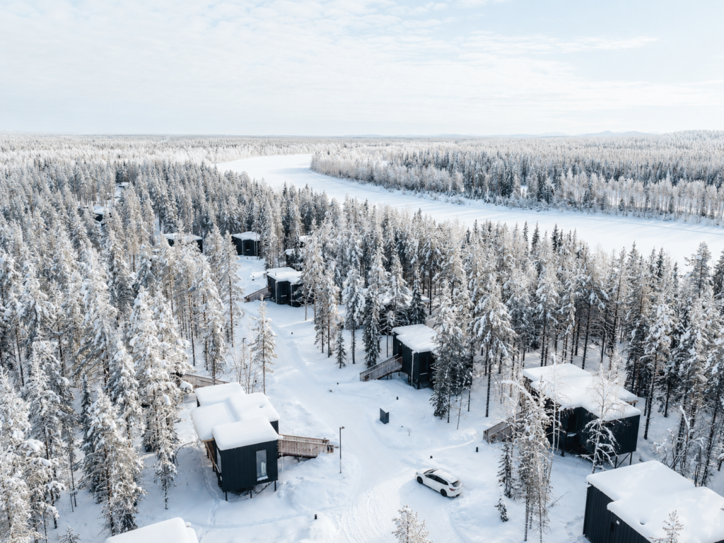 NOA Villas cabins surrounded by snowy Lapland forest.