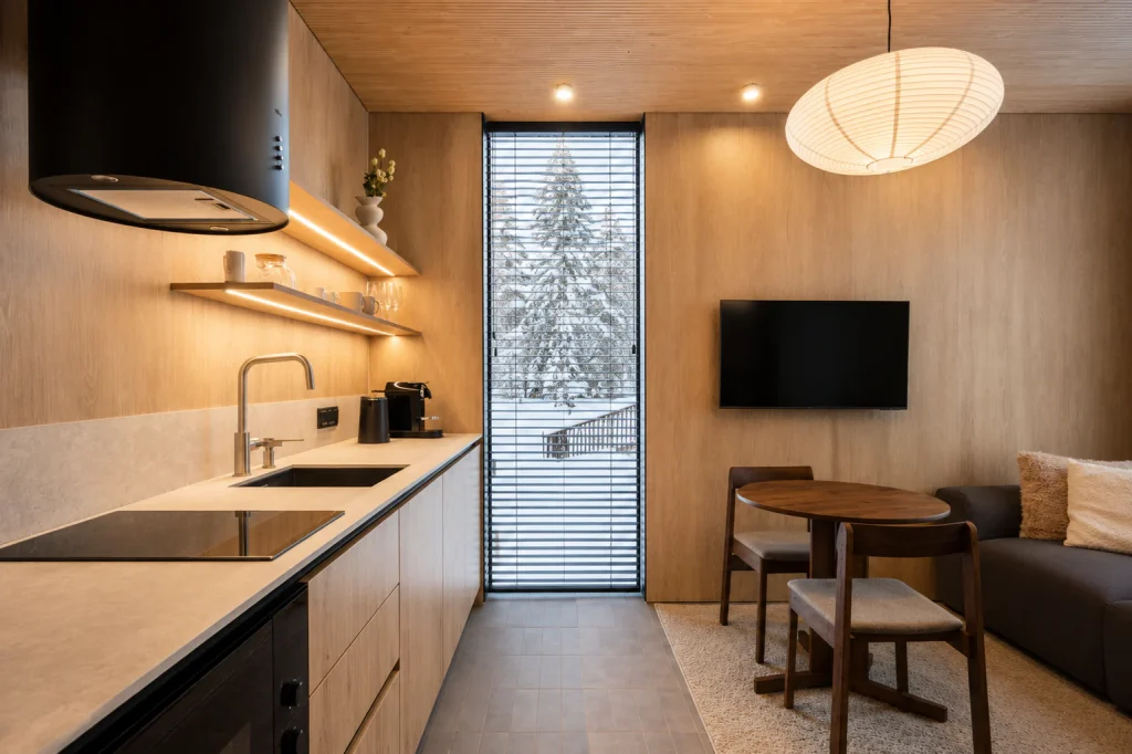 Standard Villa kitchen beside the dining nook and a snow-covered forest window.