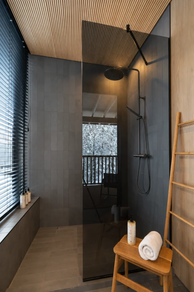 Superior Villa bathroom with a walk-in rainfall shower and timber details.
